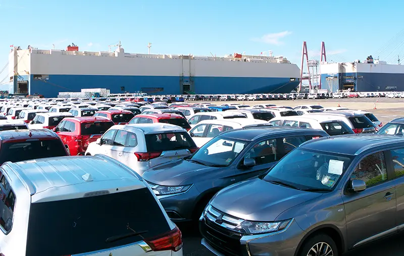 Vehicles from Japan car auctions ready for export at a Japanese port.