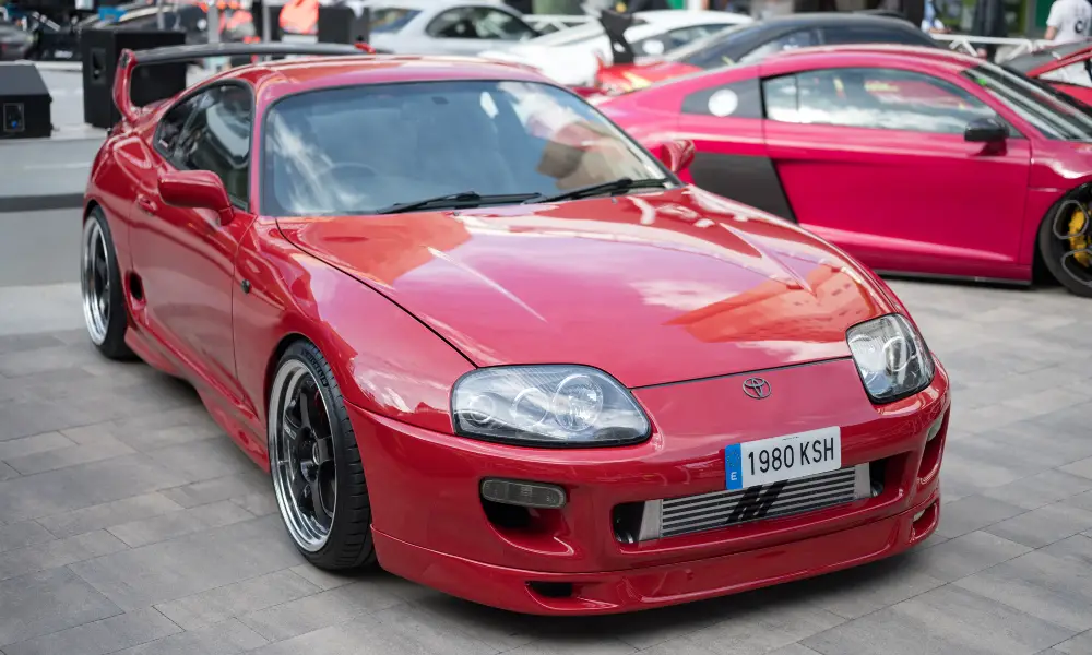 A bold red Toyota Supra A80, a legendary JDM sports car revered for its power and style.