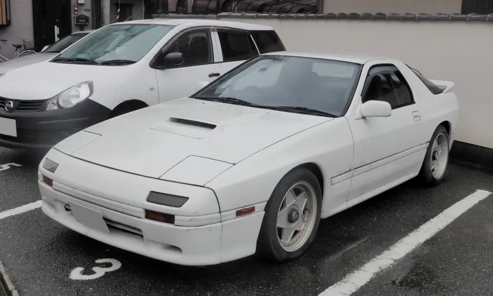 A classic JDM sports car, the Mazda RX-7 FC3S, known for its rotary engine and sharp design.