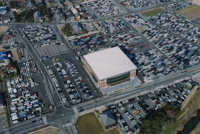 Aerial view of JU Gifu Auto Auction, showcasing its large-scale facility and extensive vehicle listings in the Japan Car Auction market.