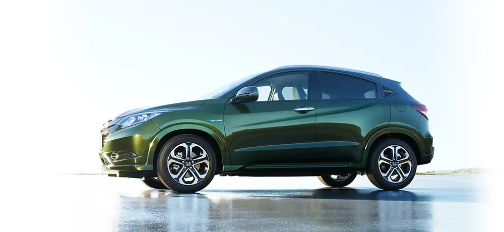 2013 Honda Vezel side profile – first-generation compact SUV with sleek green finish