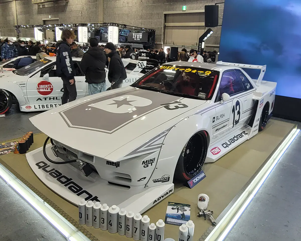 A Liberty Walk-modified S13 Silvia, featuring a racing-style aero kit and wide-body specifications.