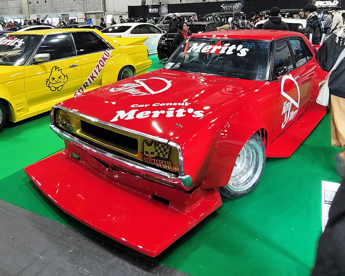 A bold Bosozoku-style Nissan Skyline Kenmeri, painted in striking red with aggressive wide fenders and a race-inspired livery.