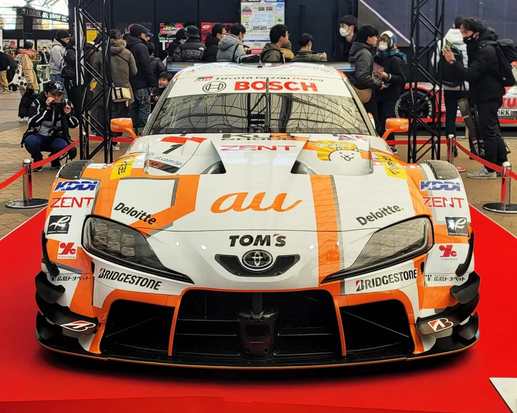 The GT500 class champion car, No.36 au TOM'S GR Supra, on display, drawing attention from many visitors.